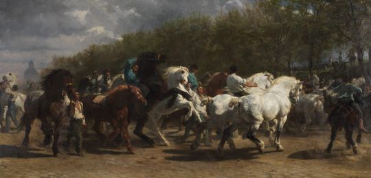 Grooms leading and riding rearing horses at a horse market in Paris