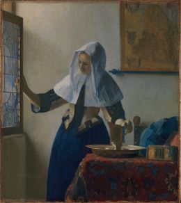 A woman in a white headscarf opening a window, her other hand on a silver pitcher